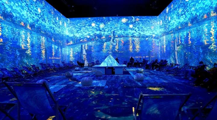 Experimente una exhibición de arte envolvente con proyecciones digitales de "La noche estrellada sobre el Ródano" de Van Gogh. Deléitese con los fascinantes tonos azules y disfrute de cómodos asientos mientras se sumerge en este mundo mágico de experiencias inmersivas.